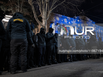 Police officers block the Georgian Parliament building as anti-government demonstrators gather outside the parliament in Tbilisi, Georgia, o...