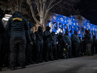 Police officers block the Georgian Parliament building as anti-government demonstrators gather outside the parliament in Tbilisi, Georgia, o...