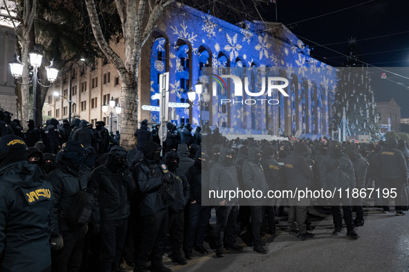 Police officers block the Georgian Parliament building as anti-government demonstrators gather outside the parliament in Tbilisi, Georgia, o...