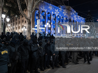 Police officers block the Georgian Parliament building as anti-government demonstrators gather outside the parliament in Tbilisi, Georgia, o...