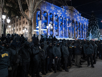 Police officers block the Georgian Parliament building as anti-government demonstrators gather outside the parliament in Tbilisi, Georgia, o...