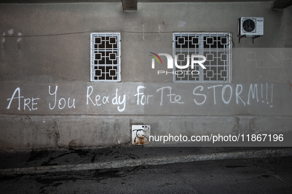 A tag on the Parliament's wall reads ''are you ready for the storm'' as anti-government demonstrators gather outside the Georgian parliament...