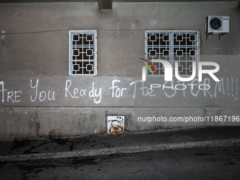 A tag on the Parliament's wall reads ''are you ready for the storm'' as anti-government demonstrators gather outside the Georgian parliament...