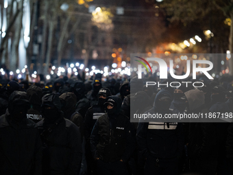 Police officers block the Georgian Parliament building as anti-government demonstrators gather outside the parliament in Tbilisi, Georgia, o...