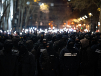 Police officers block the Georgian Parliament building as anti-government demonstrators gather outside the parliament in Tbilisi, Georgia, o...