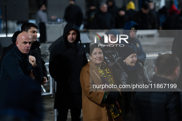 Georgia's outgoing President Salome Zourabichvili walks outside the Georgian parliament during an anti-government rally after the parliament...