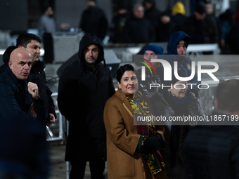 Georgia's outgoing President Salome Zourabichvili walks outside the Georgian parliament during an anti-government rally after the parliament...