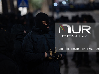 Police officers block the Georgian Parliament building as anti-government demonstrators gather outside the parliament in Tbilisi, Georgia, o...