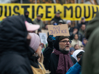 More than a thousand people take part in a demonstration against the latest court verdict over the police shooting that results in the death...