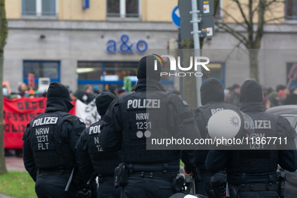 A hundred police officers observe as more than a thousand people take part in a demonstration against the latest court verdict over the poli...