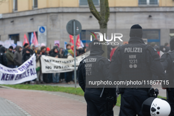 A hundred police officers observe as more than a thousand people take part in a demonstration against the latest court verdict over the poli...