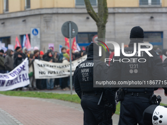 A hundred police officers observe as more than a thousand people take part in a demonstration against the latest court verdict over the poli...