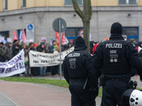 A hundred police officers observe as more than a thousand people take part in a demonstration against the latest court verdict over the poli...