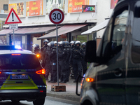 A hundred police officers observe as more than a thousand people take part in a demonstration against the latest court verdict over the poli...