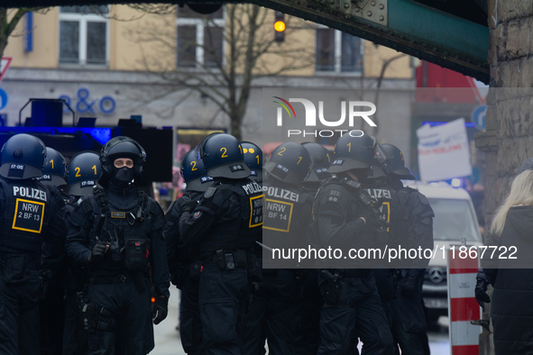 A hundred police officers observe as more than a thousand people take part in a demonstration against the latest court verdict over the poli...