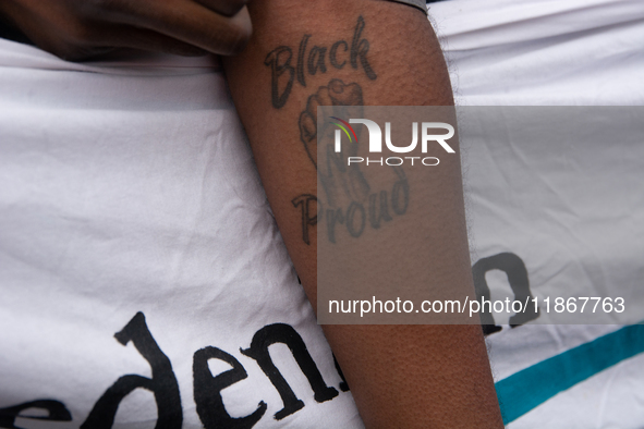 A protester with a ''Black Proud'' tattoo is seen as more than a thousand people take part in a demonstration against the latest court verdi...