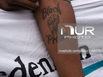 A protester with a ''Black Proud'' tattoo is seen as more than a thousand people take part in a demonstration against the latest court verdi...