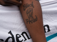 A protester with a ''Black Proud'' tattoo is seen as more than a thousand people take part in a demonstration against the latest court verdi...