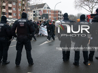 A hundred police officers observe as more than a thousand people take part in a demonstration against the latest court verdict over the poli...