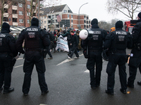 A hundred police officers observe as more than a thousand people take part in a demonstration against the latest court verdict over the poli...