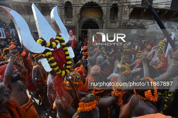 Hindu sadhus (holy men) from the Juna Akhara take part in a religious procession towards the Sangam area during the first entry for the Maha...