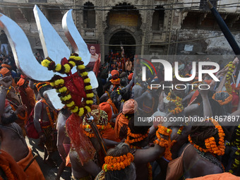 Hindu sadhus (holy men) from the Juna Akhara take part in a religious procession towards the Sangam area during the first entry for the Maha...