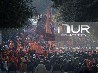 Hindu sadhus (holy men) from the Juna Akhara take part in a religious procession towards the Sangam area during the first entry for the Maha...