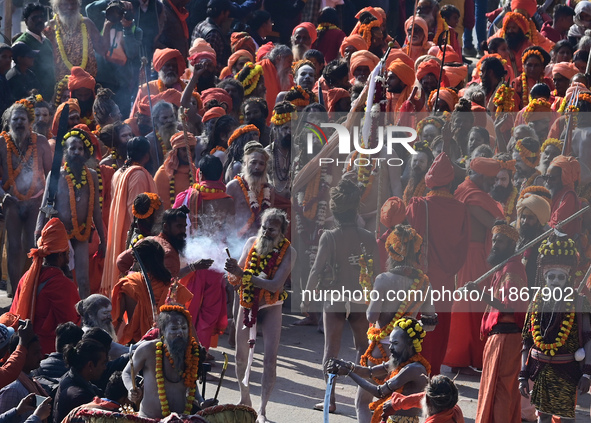 Hindu sadhus (holy men) from the Juna Akhara take part in a religious procession towards the Sangam area during the first entry for the Maha...