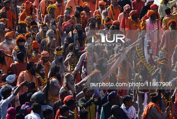 Hindu sadhus (holy men) from the Juna Akhara take part in a religious procession towards the Sangam area during the first entry for the Maha...