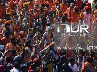 Hindu sadhus (holy men) from the Juna Akhara take part in a religious procession towards the Sangam area during the first entry for the Maha...