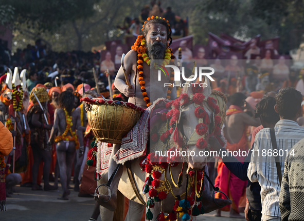 Hindu sadhus (holy men) from the Juna Akhara take part in a religious procession towards the Sangam area during the first entry for the Maha...