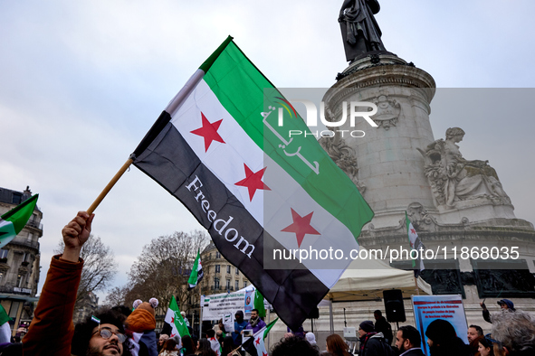 Members of the Syrian community celebrate and wave Syrian independence flags while shouting slogans during a rally in support of the Syrian...