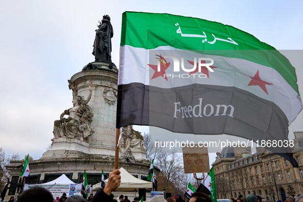 Members of the Syrian community celebrate and wave Syrian independence flags while shouting slogans during a rally in support of the Syrian...