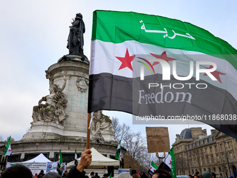 Members of the Syrian community celebrate and wave Syrian independence flags while shouting slogans during a rally in support of the Syrian...