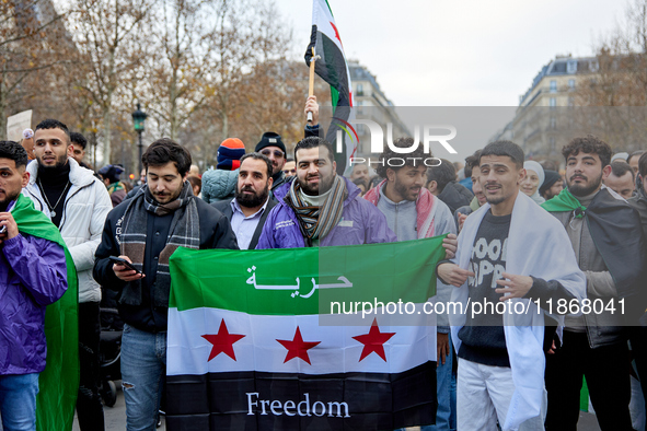 Members of the Syrian community celebrate and wave Syrian independence flags while shouting slogans during a rally in support of the Syrian...