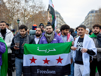 Members of the Syrian community celebrate and wave Syrian independence flags while shouting slogans during a rally in support of the Syrian...