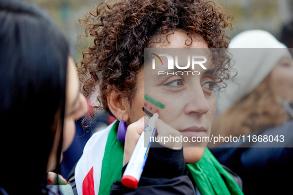 Members of the Syrian community celebrate and wave Syrian independence flags while shouting slogans during a rally in support of the Syrian...