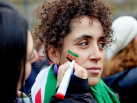 Members of the Syrian community celebrate and wave Syrian independence flags while shouting slogans during a rally in support of the Syrian...