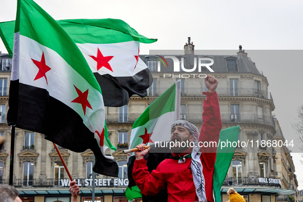 Members of the Syrian community celebrate and wave Syrian independence flags while shouting slogans during a rally in support of the Syrian...