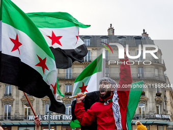 Members of the Syrian community celebrate and wave Syrian independence flags while shouting slogans during a rally in support of the Syrian...