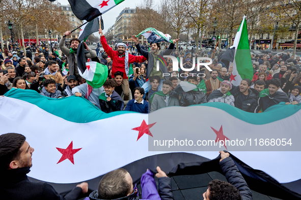 Members of the Syrian community celebrate and wave Syrian independence flags while shouting slogans during a rally in support of the Syrian...