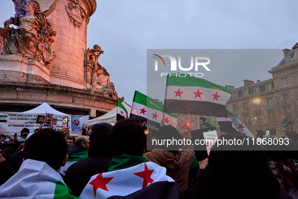 Members of the Syrian community celebrate and wave Syrian independence flags while shouting slogans during a rally in support of the Syrian...