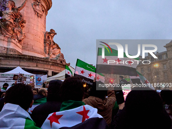 Members of the Syrian community celebrate and wave Syrian independence flags while shouting slogans during a rally in support of the Syrian...