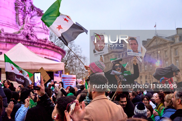 Members of the Syrian community celebrate and wave Syrian independence flags while shouting slogans during a rally in support of the Syrian...