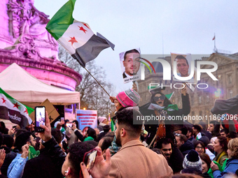 Members of the Syrian community celebrate and wave Syrian independence flags while shouting slogans during a rally in support of the Syrian...