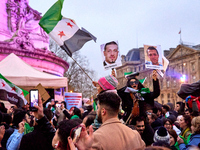 Members of the Syrian community celebrate and wave Syrian independence flags while shouting slogans during a rally in support of the Syrian...