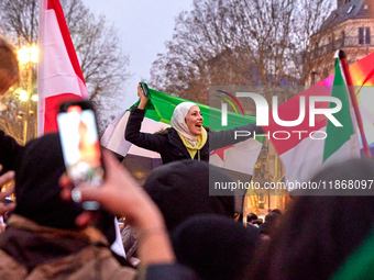 Members of the Syrian community celebrate and wave Syrian independence flags while shouting slogans during a rally in support of the Syrian...