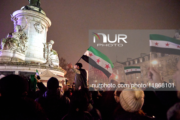 Members of the Syrian community celebrate and wave Syrian independence flags while shouting slogans during a rally in support of the Syrian...