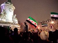 Members of the Syrian community celebrate and wave Syrian independence flags while shouting slogans during a rally in support of the Syrian...