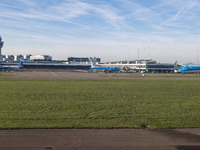 Aerial panoramic view of Amsterdam Airport Schiphol AMS EHAM from a departing airplane window with a JetBlue Airbus A321LR and a Boeing 737...